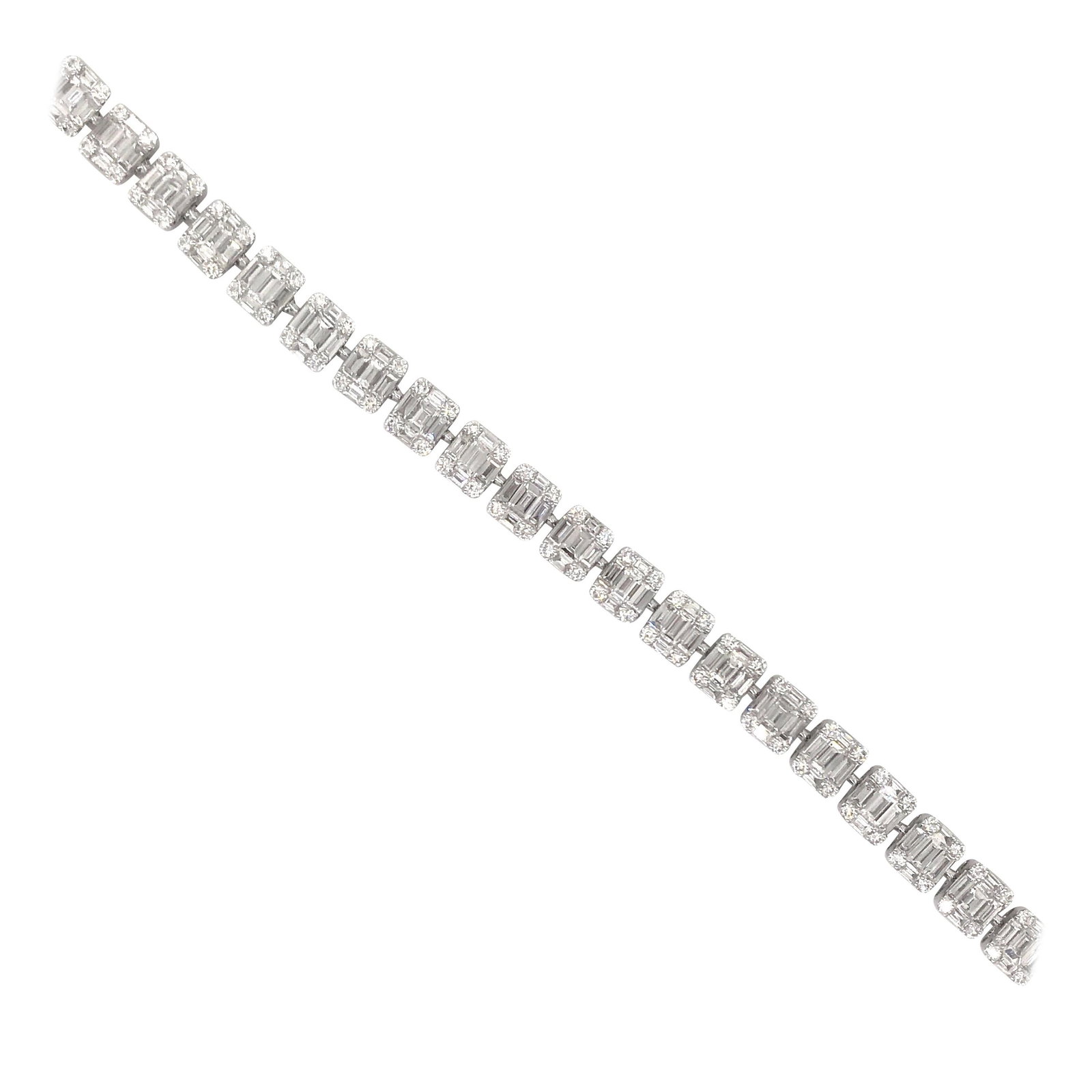 18K White Gold Illusion Bracelet with Baguette and Round Diamonds: 18K White Gold Illusion Bracelet with Baguette and Round Diamonds This contemporary illusion tennis bracelet is crafted from 18K white gold and features an impressive array of diamonds. The design sho