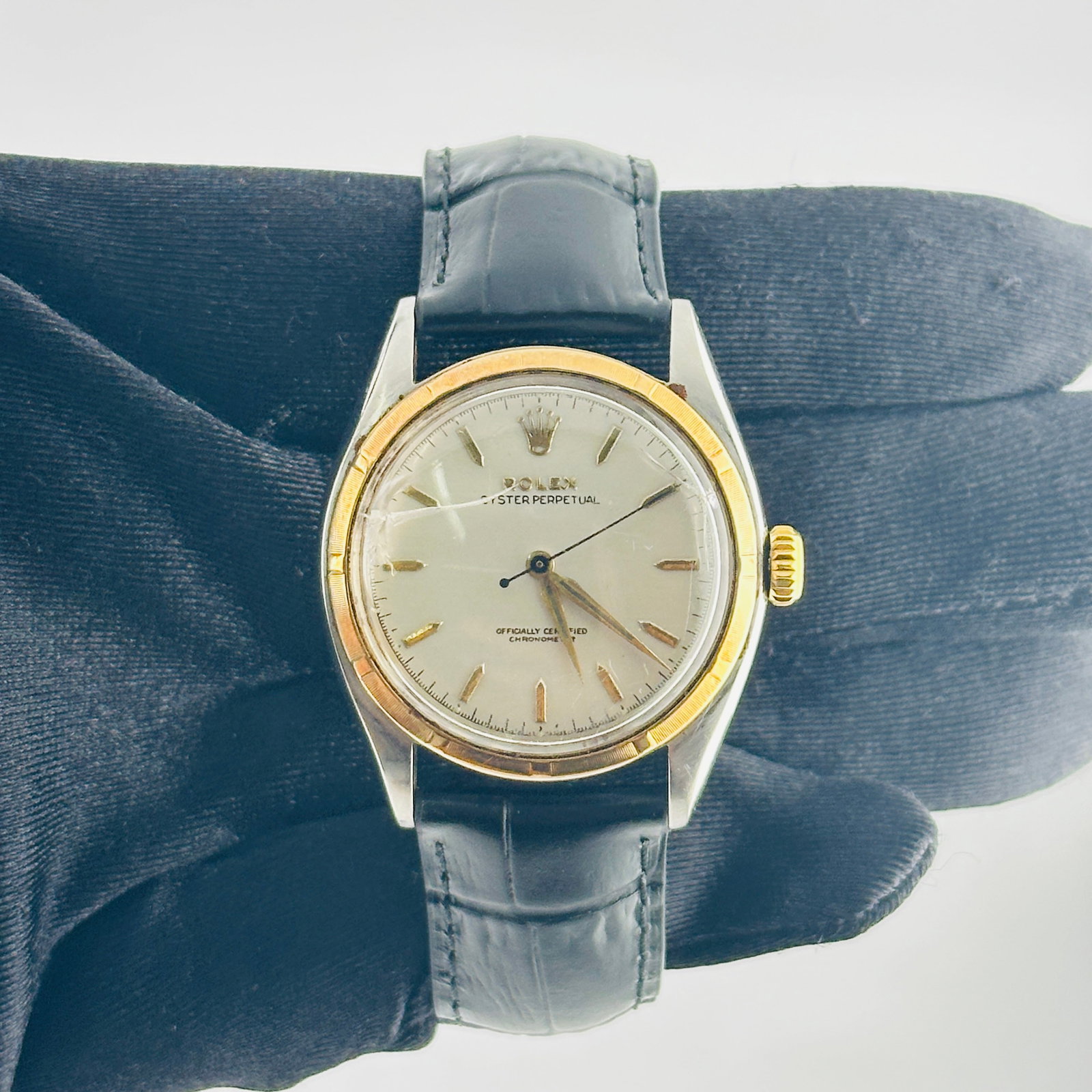 Rolex Oyster Perpetual Super Oyster 6085 Grey Gold Dial Leather Band: Rolex Oyster Perpetual Super Oyster 6085 Grey Gold Dial Leather Band This Rolex Oyster Perpetual Super Oyster features a distinctive grey and gold stick dial, complemented by an engine-turned bezel. T