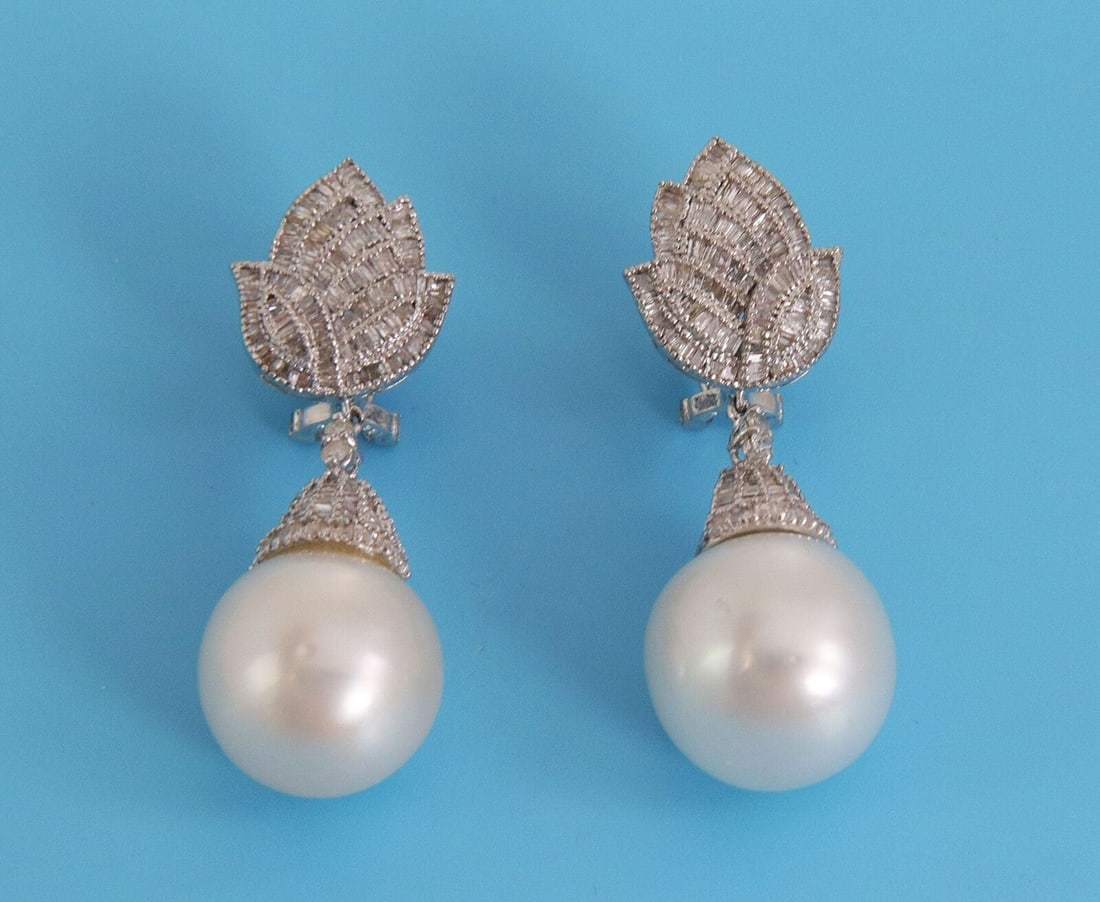 Floral Pearl Drop Earrings with Baguette Diamonds in 18k White Gold: Floral Pearl Drop Earrings with Baguette Diamonds in 18k White Gold Vintage estate dangle/drop earrings crafted in solid 18k white gold with a floral-inspired design. The earrings feature diamond tops