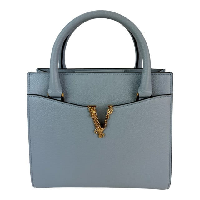 Versace Virtus Light Blue Grained Calfskin Tote Bag with Gold Accents: Versace Virtus Light Blue Grained Calfskin Tote Bag with Gold Accents Elevate your accessory collection with the Versace Virtus Top Handle Tote, crafted from luxurious grained calfskin in a stunning l