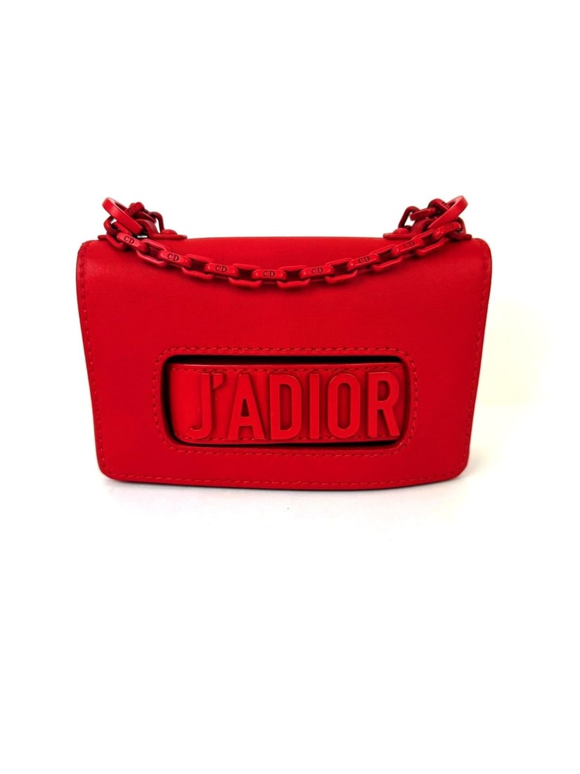 Dior J'Adior Mini Ultra Matte Red Calfskin Flap Bag with Chain Strap: Dior J'Adior Mini Ultra Matte Red Calfskin Flap Bag with Chain Strap This Christian Dior Ultra Matte Calfskin Mini J'Adior Red Flap Bag Clutch features a rectangular silhouette with a magnetic closure