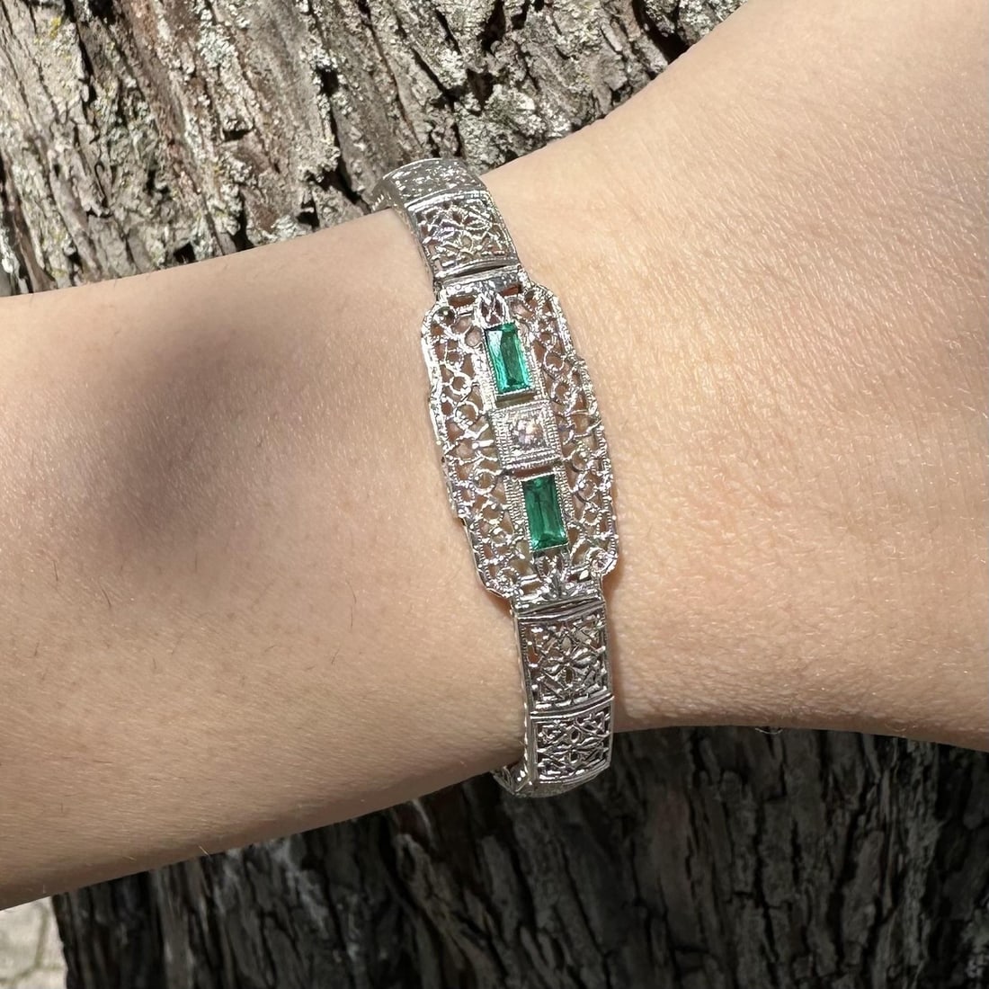 Art Deco Filigree Bracelet in White Gold Platinum with Diamond and Green Stones: Art Deco Filigree Bracelet in White Gold Platinum with Diamond and Green Stones This antique Art Deco bracelet features intricate filigree craftsmanship in solid 13-14k white gold with a platinum top.