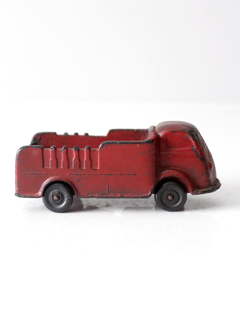 1940s Auburn Rubber Co Vintage Toy Delivery Truck: 1940s Auburn Rubber Co Vintage Toy Delivery Truck Introduce a piece of nostalgia with this vintage 1940's Auburn Rubber Co. toy delivery truck. This charming collectible features a well-loved, worn pa