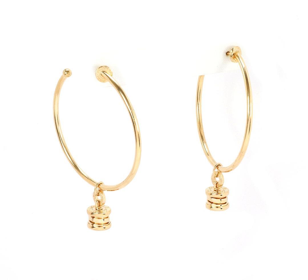 Bvlgari B Zero-1 18k Yellow Gold Dangle Hoop Earrings: Bvlgari B Zero-1 18k Yellow Gold Dangle Hoop Earrings Introducing a stunning pair of authentic Bvlgari B Zero-1 dangle hoop earrings, expertly crafted from luxurious 18k yellow gold. Each earring feat