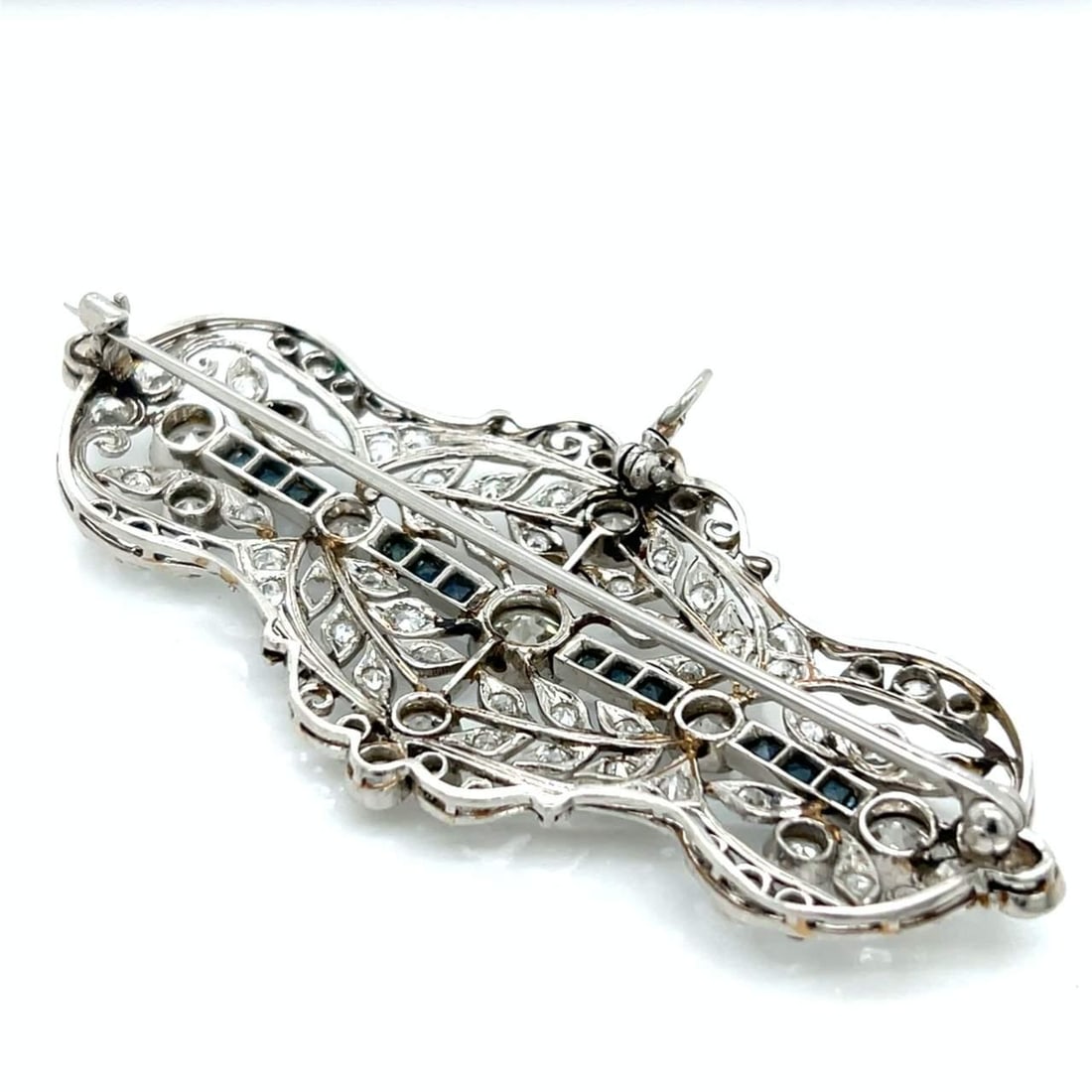Art Deco Platinum Pendant Brooch with Diamonds and Sapphires: Art Deco Platinum Pendant Brooch with Diamonds and Sapphires This exquisite Art Deco pendant/brooch is crafted in platinum and features a stunning design adorned with a central European-cut diamond ap