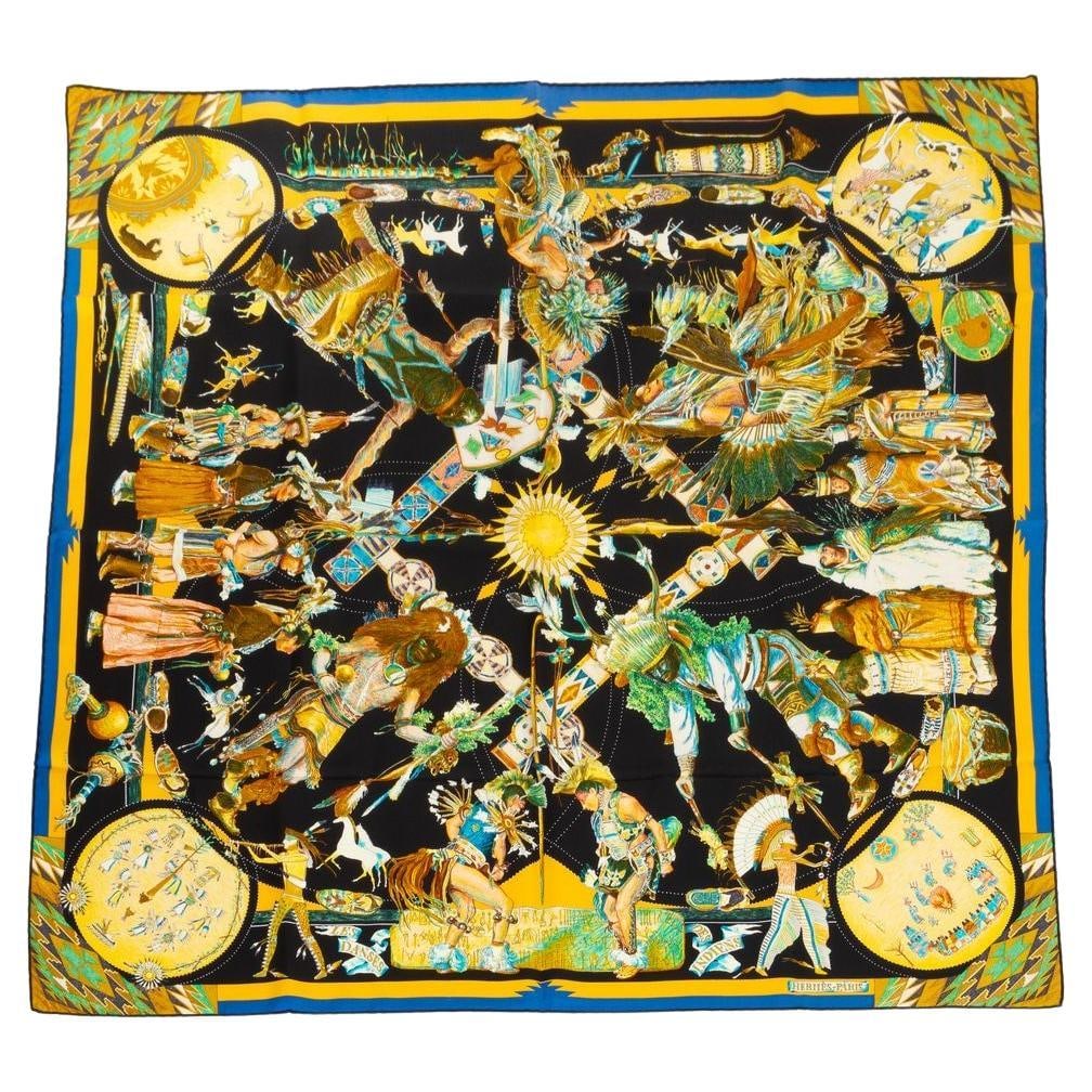 Hermes Les Danses des Indiens Silk Scarf by Kermit Oliver Black: Hermes Les Danses des Indiens Silk Scarf by Kermit Oliver Black This Hermes "Les Danses des Indiens" scarf is crafted from 100% silk twill and features hand-rolled edges. Designed by renowned US artis