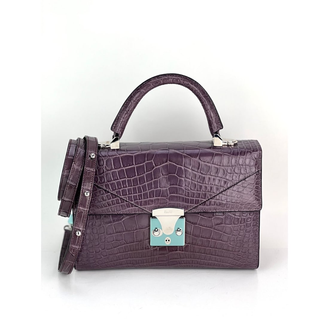 Stalvey 2.5 Alligator Lilac Luxury Crossbody Bag with Silver Hardware: Stalvey 2.5 Alligator Lilac Luxury Crossbody Bag with Silver Hardware Introducing the Stalvey Top Handle 2.5 Alligator Lilac Bag, an exclusive luxury accessory that epitomizes elegance and style. This