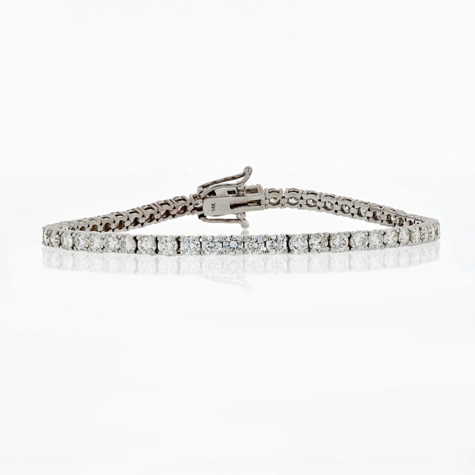 14K White Gold Tennis Bracelet with 6.56 Carat Diamonds and Four Prong Setting: 14K White Gold Tennis Bracelet with 6.56 Carat Diamonds and Four Prong Setting This pre-owned tennis bracelet is crafted from 14K white gold and features a secure 4-prong setting. It is designed in a 