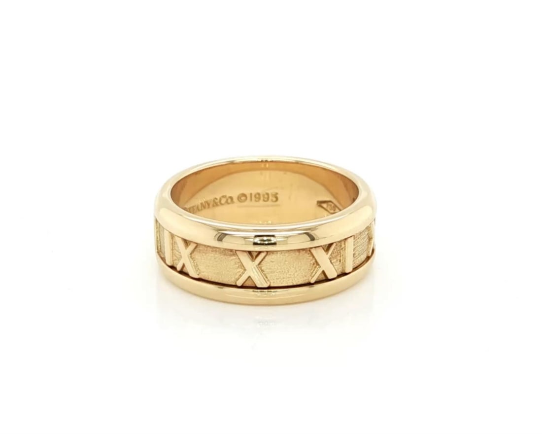 Tiffany & Co. Atlas Roman Numeral 18k Yellow Gold Ring Size 5: Tiffany & Co. Atlas Roman Numeral 18k Yellow Gold Ring Size 5 Tiffany & Co. Atlas Roman Numeral Band Ring in 18k yellow gold, featuring the collection's iconic sculpted band design and polished finish