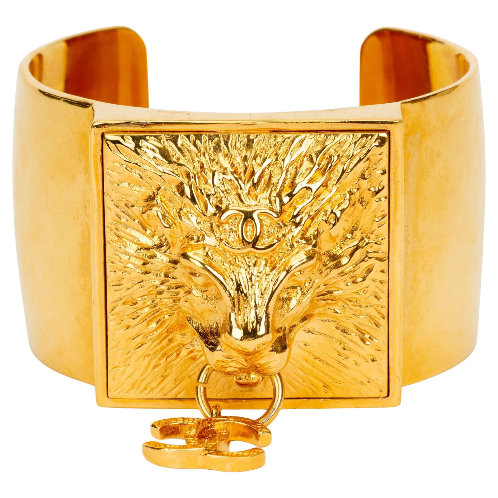 Chanel Small Gold Plated Lion Medallion Cuff Bracelet with CC Charms: Chanel Small Gold Plated Lion Medallion Cuff Bracelet with CC Charms This Chanel Lion Head Cuff features a prominent, textured lion head medallion at the center, complemented by dangling interlocking 