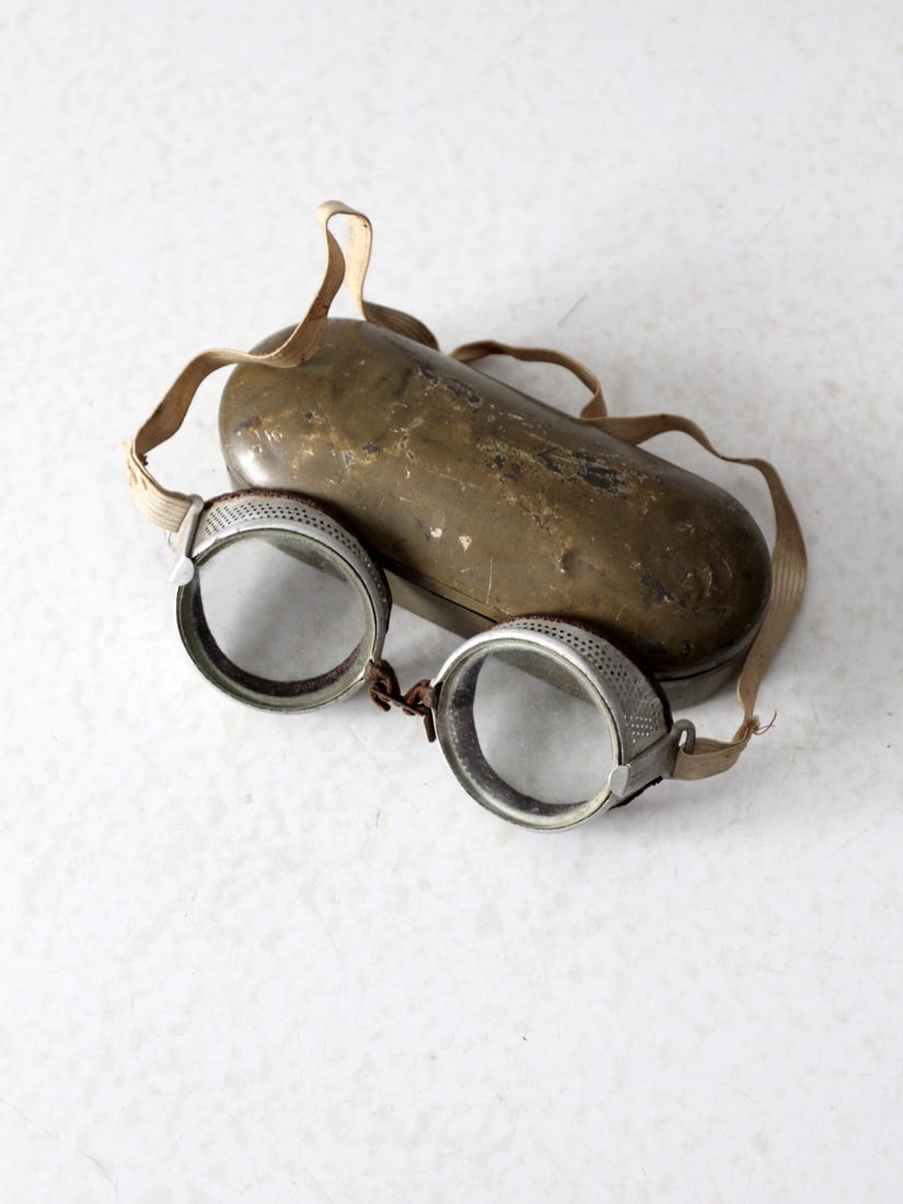 1940's Vintage Wilson Goggles with Original Metal Case: 1940's Vintage Wilson Goggles with Original Metal Case Discover a unique vintage find with these 1940's Wilson goggles, featuring a distinctive metal perforated frame. They come with their original me