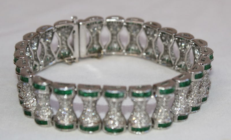 1940s French 18K White Gold Diamond Emerald Bracelet 18K BA: 1940s French 18K White Gold Diamond Emerald Bracelet 18K BA This exquisite 1940's French bracelet is crafted from 18K white gold and adorned with sparkling diamonds and vibrant emeralds. Weighing appr