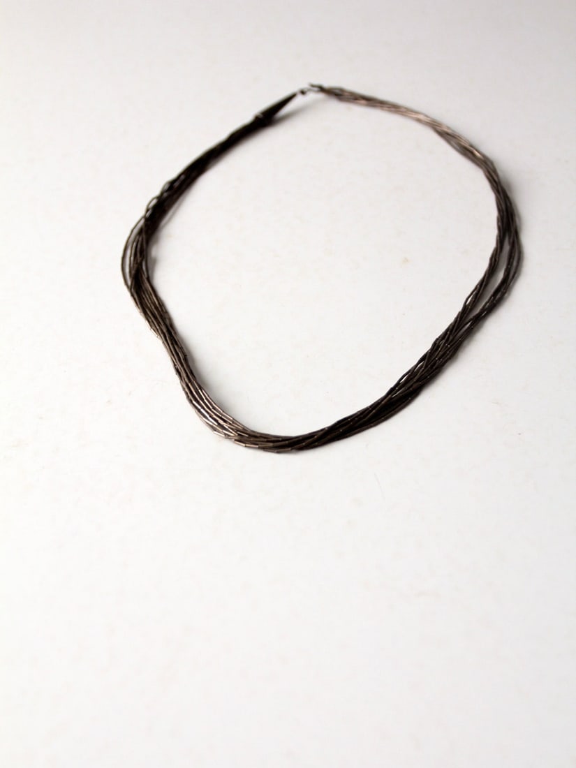 Vintage Liquid Silver Necklace 24 Inch Slinky Heshi Beads: Vintage Liquid Silver Necklace 24 Inch Slinky Heshi Beads This vintage "liquid silver" necklace showcases multiple slinky silver heshi beaded strands, elegantly designed with a hook back closure. The 