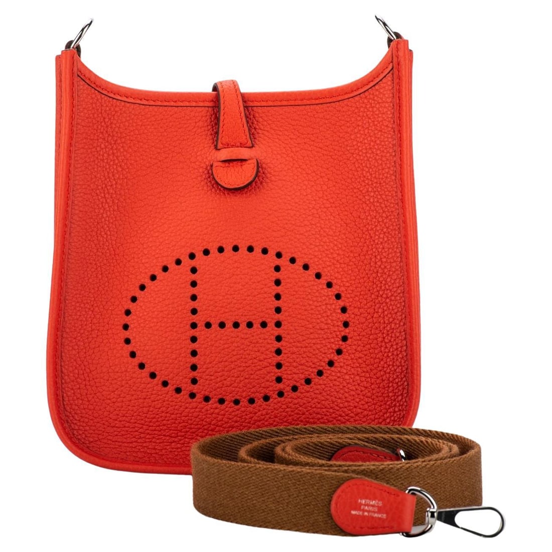Hermes Mini Evelyne Capucine Taurillon Clemence Bag with Gold Strap: Hermes Mini Evelyne Capucine Taurillon Clemence Bag with Gold Strap Introducing the Hermes Mini Evelyne bag in a vibrant Capucine color, crafted from durable taurillon clemence leather. This luxurious