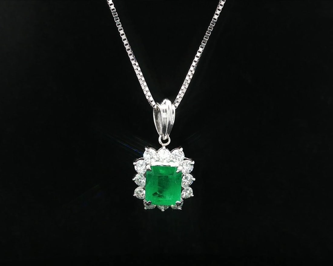 GIA Colombian Emerald Diamond Halo Pendant Necklace 14k White Gold Platinum: GIA Colombian Emerald Diamond Halo Pendant Necklace 14k White Gold Platinum This elegant pendant necklace features a vivid green Colombian emerald, certified by GIA, as its centerpiece. The octagonal 