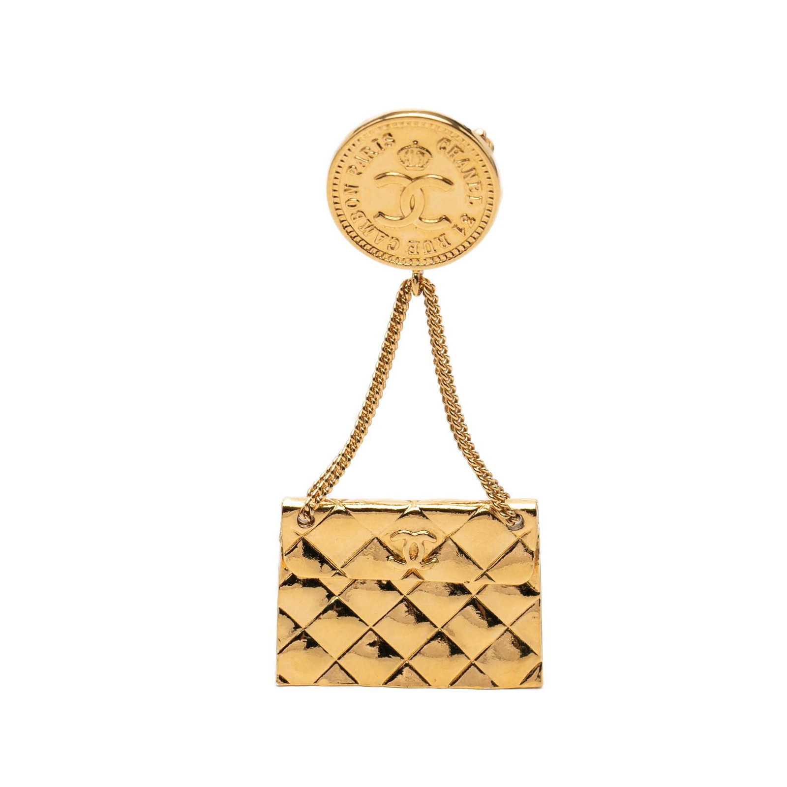 Chanel Quilted Flap Bag Medallion CC Gold Tone Brooch: Chanel Quilted Flap Bag Medallion CC Gold Tone Brooch Gold-tone metal brooch in the form of a quilted flap bag medallion, featuring a back pin closure. It is a costume piece made in France and present