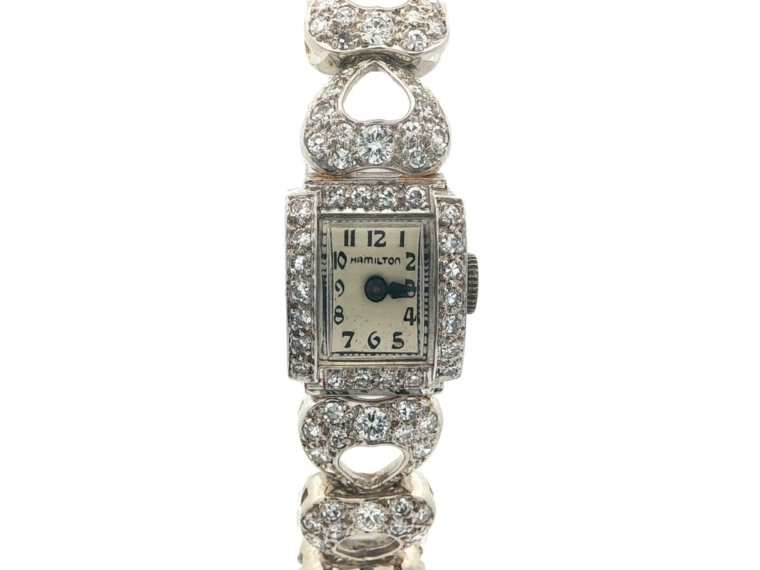 Hamilton Platinum Diamond Heart Link Vintage Watch with 5.42ct Round Stones: Hamilton Platinum Diamond Heart Link Vintage Watch with 5.42ct Round Stones This vintage Hamilton wristwatch features a solid platinum case and bracelet with heart link detailing. The watch is adorned