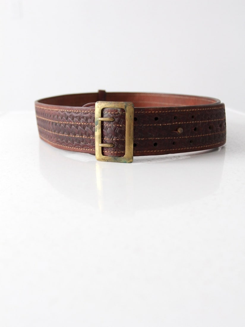 Bucheimer Clark Vintage Leather Utility Belt with Brass Buckle: Bucheimer Clark Vintage Leather Utility Belt with Brass Buckle This vintage leather utility belt by Bucheimer Clark is a classic piece that combines style and functionality. Crafted from high-quality 