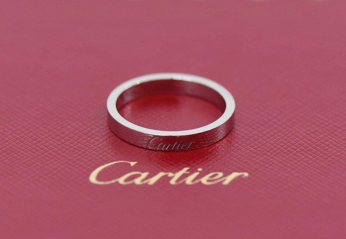 C de Cartier Platinum Band Ring Size 56 with Box and Service Receipt: C de Cartier Platinum Band Ring Size 56 with Box and Service Receipt This Cartier C de Cartier ring is crafted from 950 platinum and features a sleek, minimalist design without a main stone. The ring 