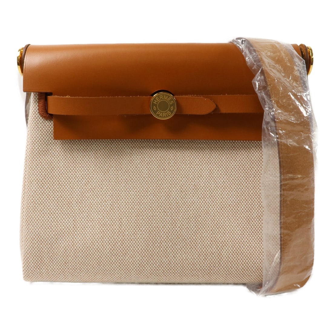 Hermes Mini Herbag Canvas Shoulder Bag Ecru Beige Fauve: Hermes Mini Herbag Canvas Shoulder Bag Ecru Beige Fauve Hermes Mini Herbag shoulder bag in canvas with a Beige/Ecru Beige/Fauve colorway. This women's regular-size bag is made in France and comes with