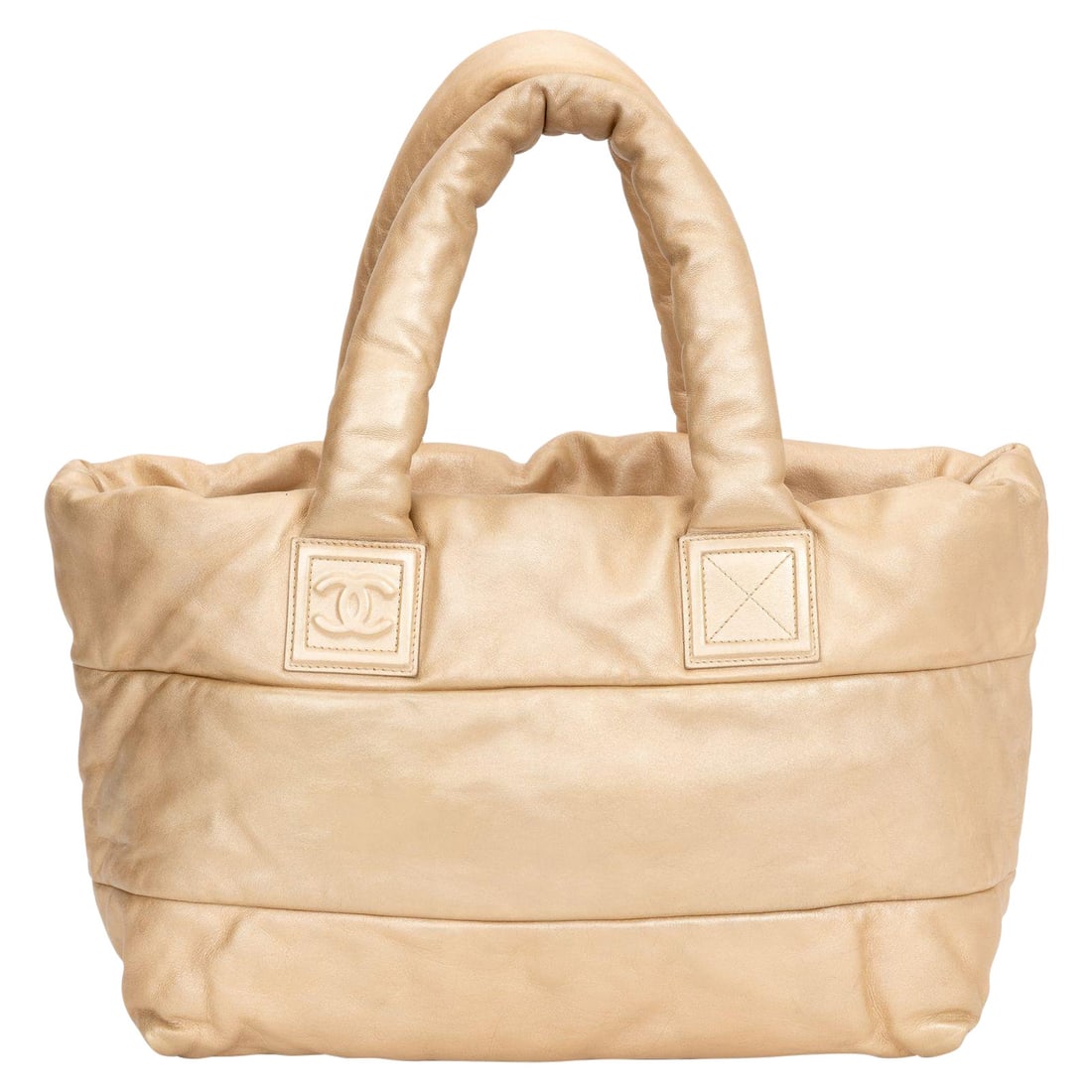 Chanel Coco Cocoon Tote Bag Gold Lambskin with Certificate: Chanel Coco Cocoon Tote Bag Gold Lambskin with Certificate Introducing the Chanel Gold Leather Coco Cocoon Tote Bag, a luxurious and stylish accessory for daily use. Crafted from soft lambskin, this t