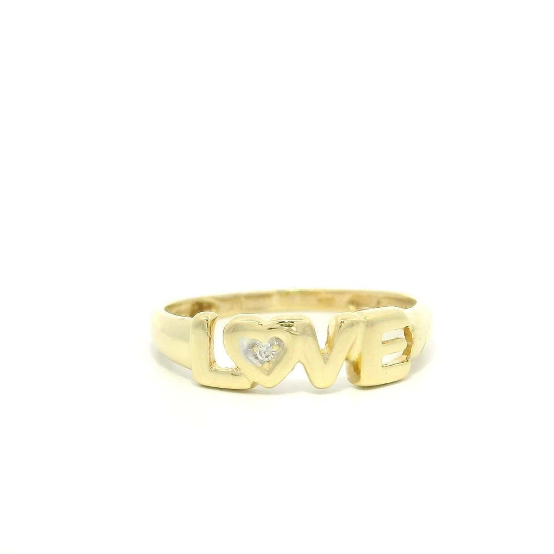 14k Yellow Gold Diamond LOVE Band Signet Ring Size 6.5: 14k Yellow Gold Diamond LOVE Band Signet Ring Size 6.5 This exquisite 14k Yellow Gold Band Ring features a beautifully crafted 'LOVE' signet design, highlighted by a single natural diamond. The diamon