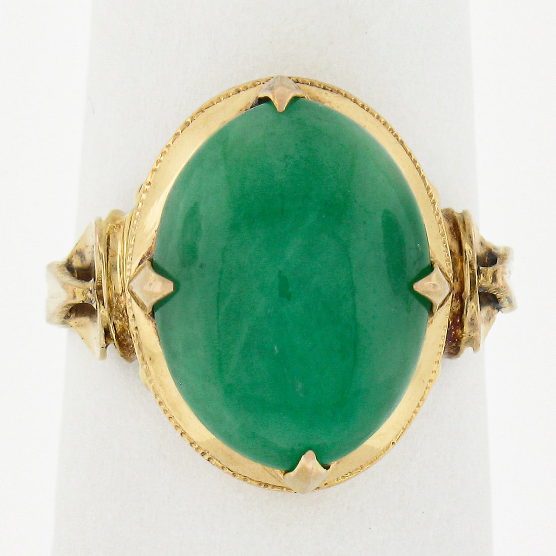 Vintage 14K Yellow Gold Oval Cabochon Jade Cocktail Ring Size 5: Vintage 14K Yellow Gold Oval Cabochon Jade Cocktail Ring Size 5 This exquisite vintage cocktail ring showcases a stunning oval cabochon cut jade stone, beautifully set in solid 14K yellow gold. The na