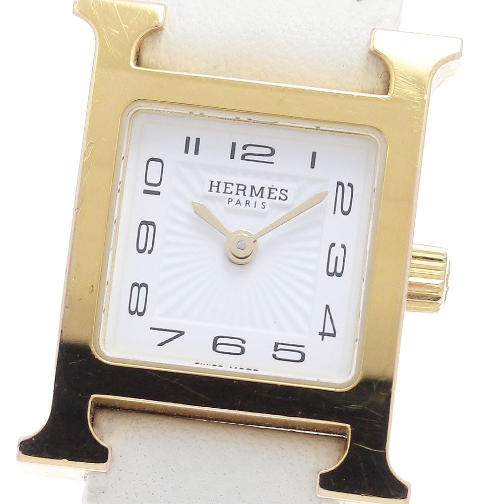 Hermes H Watch Mini HH1.101 womens quartz wristwatch: Hermes H Watch Mini HH1.101 womens quartz wristwatch HERMES H Watch Mini women's wristwatch, model HH1.101, with a Swiss quartz movement. It features a white dial, stainless steel and gold plated case