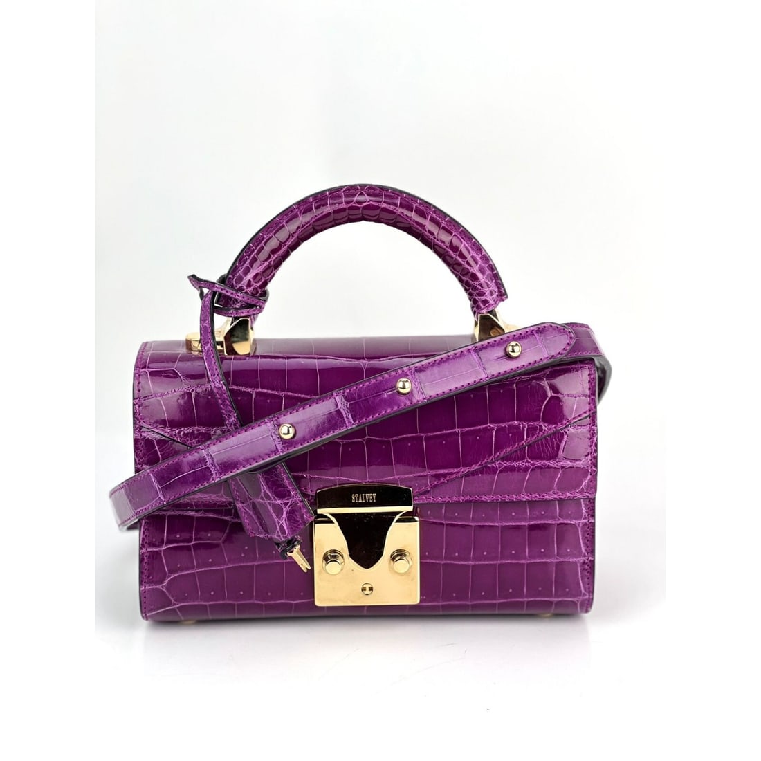 Stalvey 2.0 magenta alligator top handle crossbody bag: Stalvey 2.0 magenta alligator top handle crossbody bag Introducing the Exclusive Stalvey Top Handle 2.0 Alligator Bag, a luxurious addition to your formal wardrobe. This exquisite crossbody bag featur