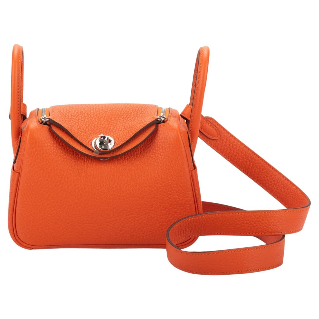 Hermes Mini Lindy Feu Taurillon Clemence with Palladium Hardware: Hermes Mini Lindy Feu Taurillon Clemence with Palladium Hardware Introducing the exquisite Hermes Mini Lindy in Feu with Palladium hardware, a stunning addition to any designer collection. This brand 