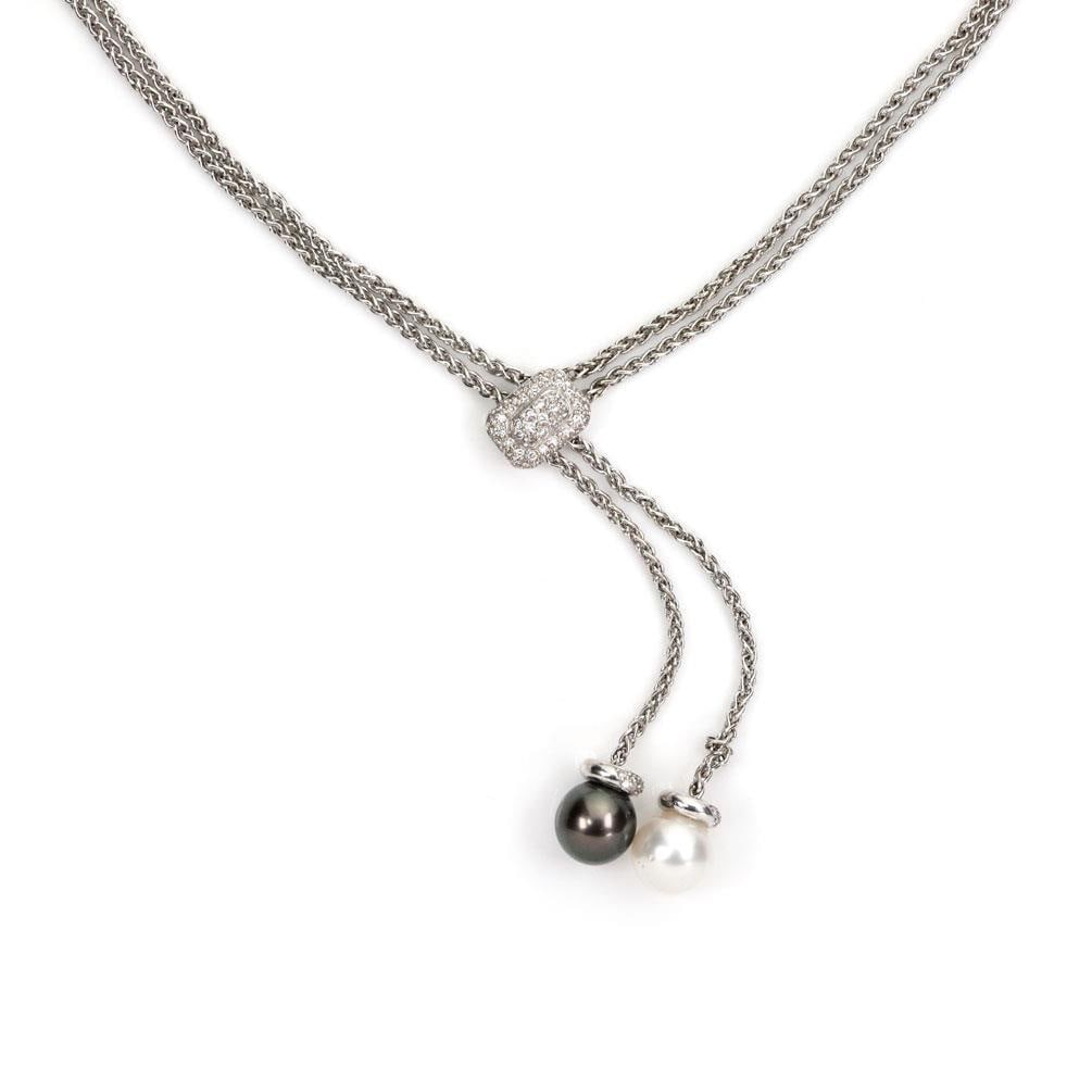 18k White Gold Lariat Necklace with Diamond Pearls: 18k White Gold Lariat Necklace with Diamond Pearls This elegant double chain lariat necklace is crafted from 18k white gold and features a unique adjustable center pendant clasp. The clasp is embellis