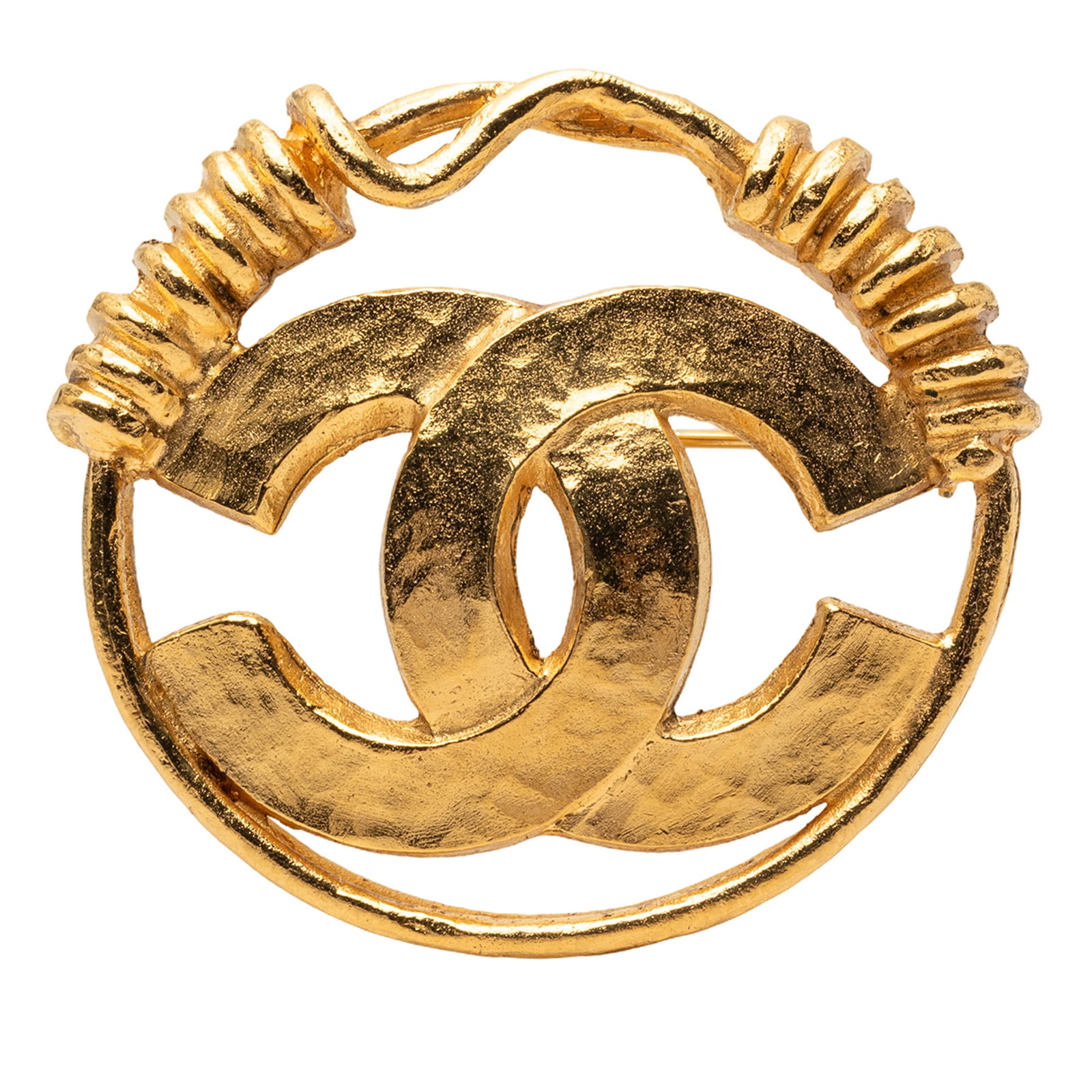 Chanel Round Gold Tone Metal Brooch with CC Logo: Chanel Round Gold Tone Metal Brooch with CC Logo This Chanel brooch features a gold-tone metal body with the iconic CC motif and a round spring design. It is designed with a pin closure for secure fas
