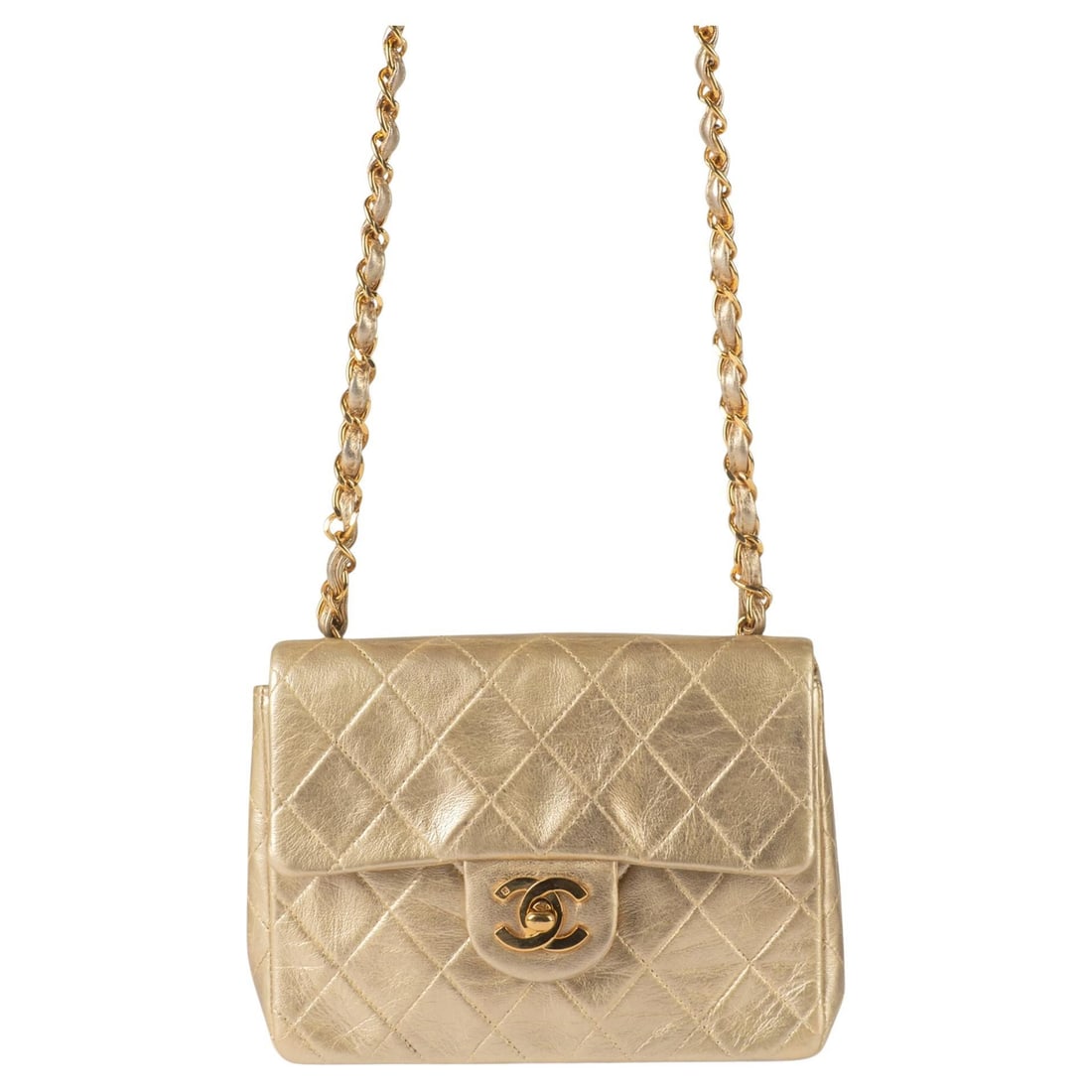 Chanel Vintage Gold Mini Flap Bag with Hologram and Box: Chanel Vintage Gold Mini Flap Bag with Hologram and Box This Chanel Vintage Gold Mini CrossBody Flap is a luxurious accessory that embodies elegance and style. Crafted from soft gold lambskin, it feat