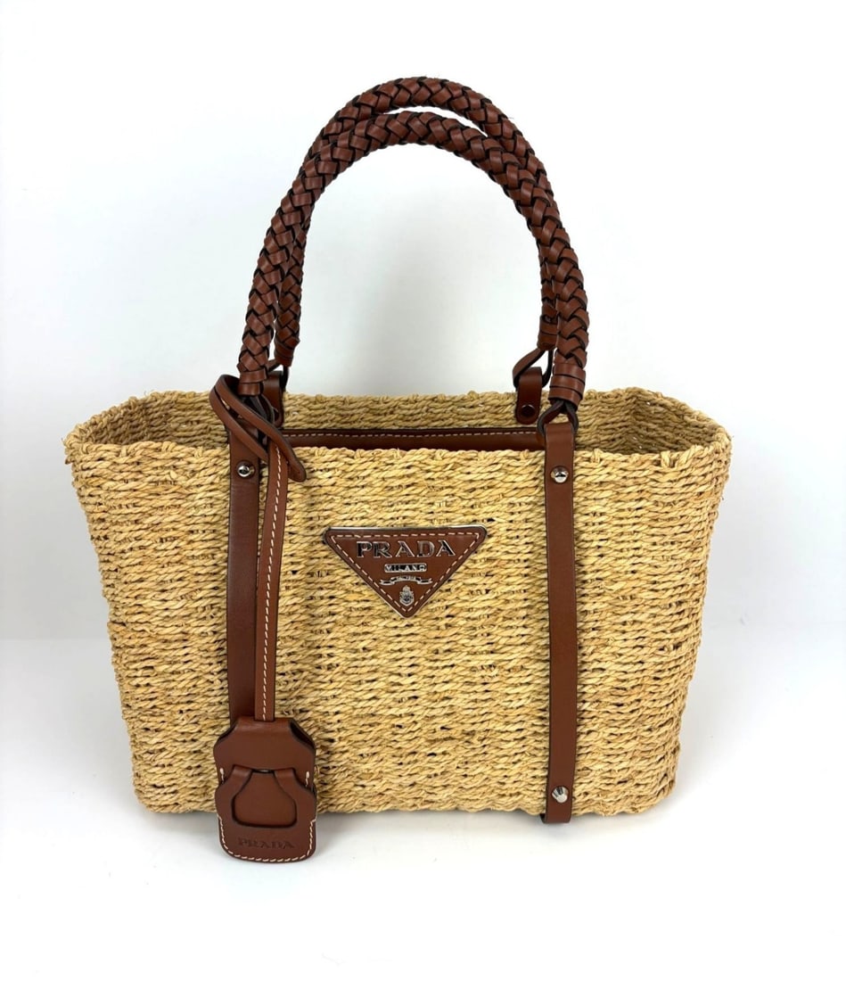 Prada Palmetto Small Woven Canvas Raffia Trapezoid Tote with Leather Handles: Prada Palmetto Small Woven Canvas Raffia Trapezoid Tote with Leather Handles This Prada Palmetto Vitello tote bag features a small, trapezoid shape crafted from woven canvas raffia with brown leather 