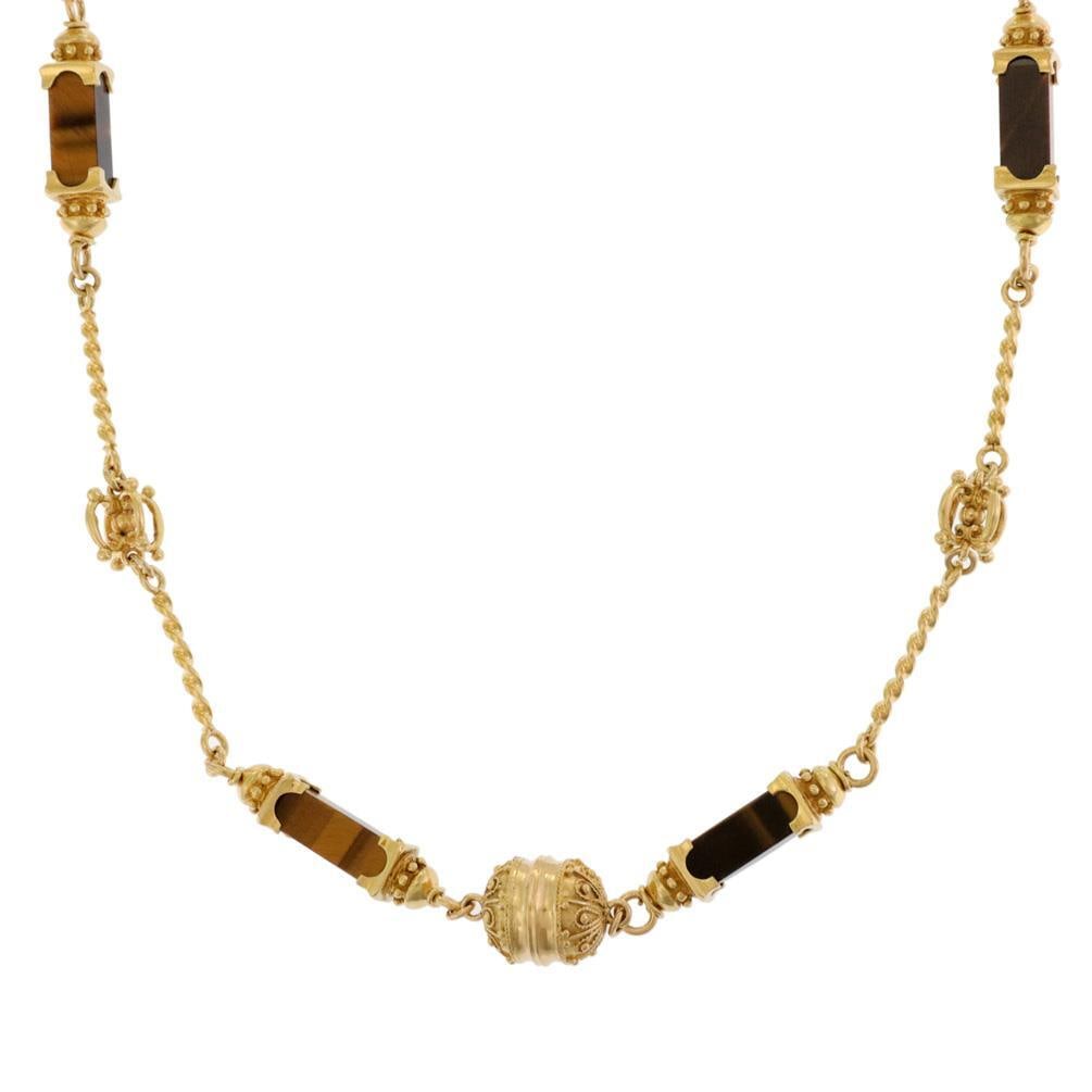Elegant 18k Yellow Gold Tiger's Eye Long Necklace with Enhancers: Elegant 18k Yellow Gold Tiger's Eye Long Necklace with Enhancers This stunning long necklace is crafted from 18k yellow gold, featuring a twisted wire cable design adorned with five fancy open-style e