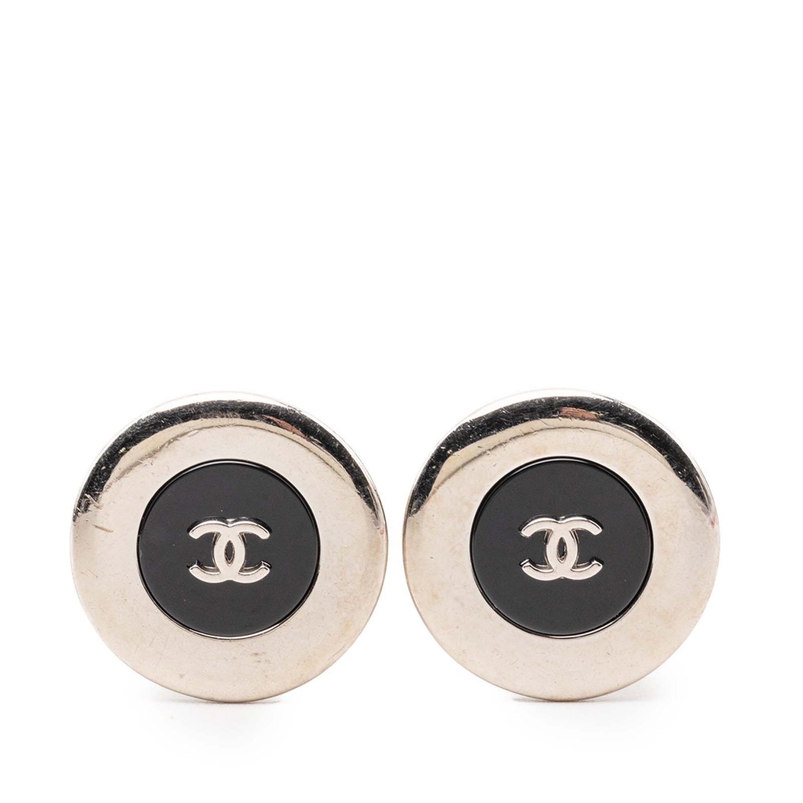 Chanel CC Button Clip On Earrings Silver Tone Enamel: Chanel CC Button Clip On Earrings Silver Tone Enamel These Chanel clip-on earrings feature a silver-tone metal body with enamel detailing and the iconic CC button design. Made in France, these costume