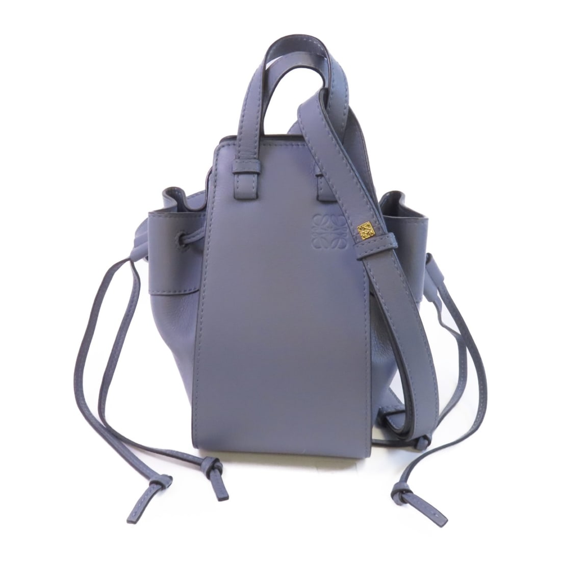 LOEWE Hammock Mini calfskin crossbody shoulder bag in blue: LOEWE Hammock Mini calfskin crossbody shoulder bag in blue The LOEWE Hammock Mini is a shoulder bag and crossbody bag crafted from calfskin leather in blue. It features two open interior pockets and c