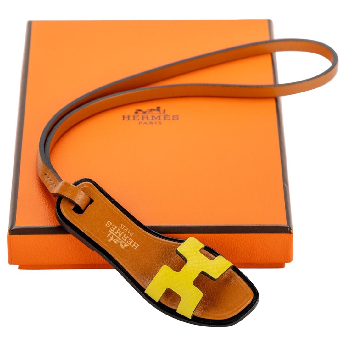 Hermes Rare Mini Oran Bag Charm in Gold Yellow Leather: Hermes Rare Mini Oran Bag Charm in Gold Yellow Leather Introducing a stunning mini Oran bag charm from Hermes, a rare collectible that embodies luxury and style. This exquisite accessory is crafted fr
