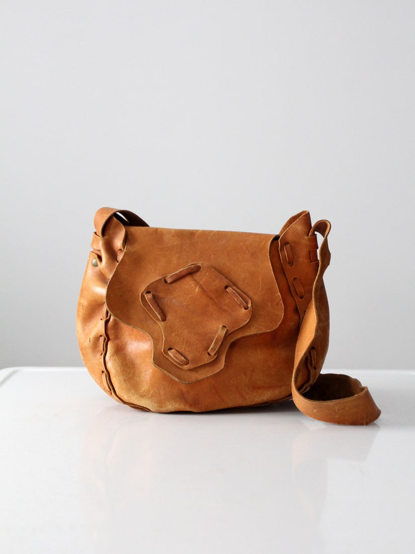 70s Vintage Hippie Boho Leather Shoulder Bag: 70s Vintage Hippie Boho Leather Shoulder Bag Discover the charm of the 1970s with this hand-crafted boho leather shoulder bag. Made from soft caramel leather, this vintage hippie bag features distinct