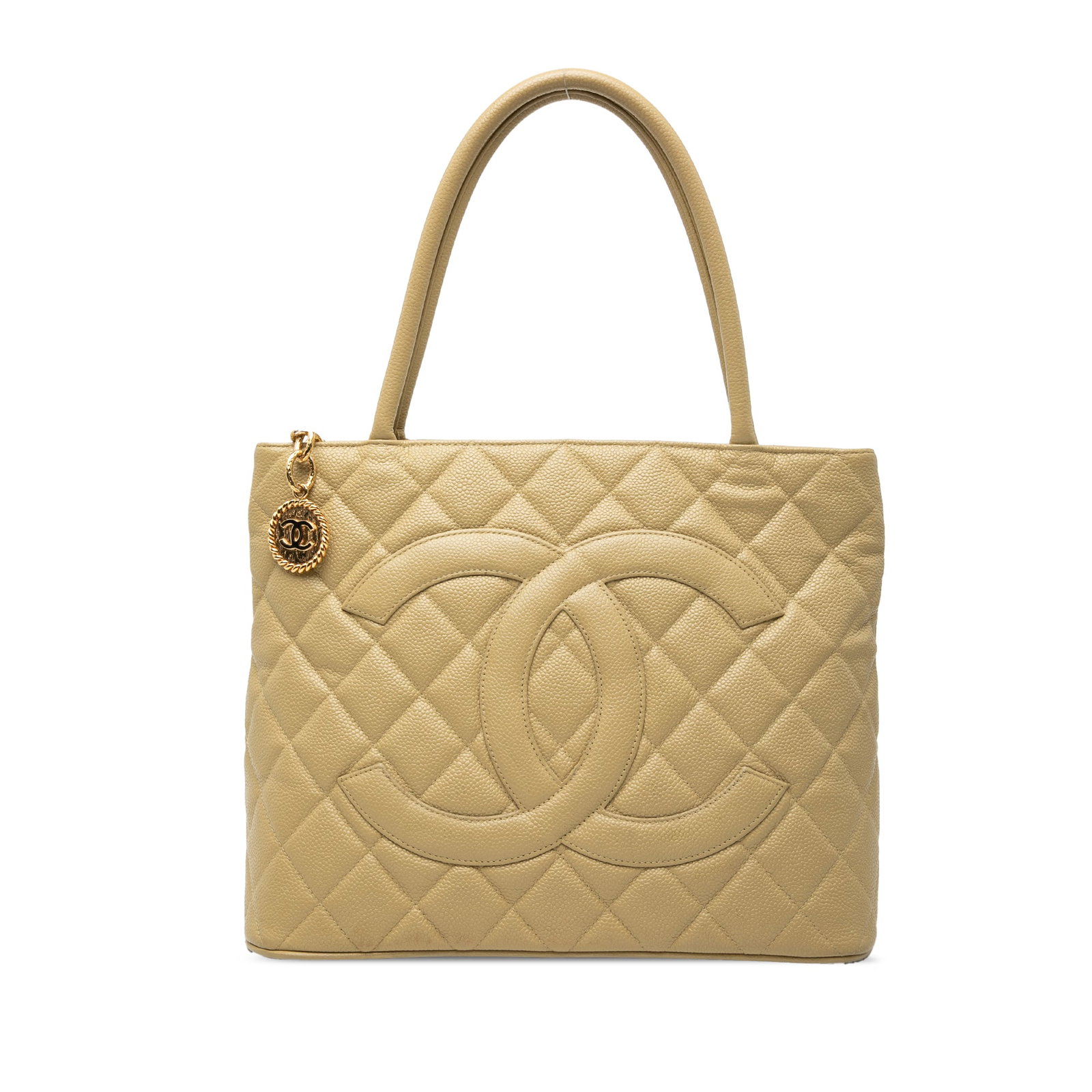 Chanel beige caviar leather Medallion tote bag: Chanel beige caviar leather Medallion tote bag This Chanel Caviar Medallion Tote features a quilted caviar leather exterior in beige, complemented by rolled leather handles and a top zip closure. The 