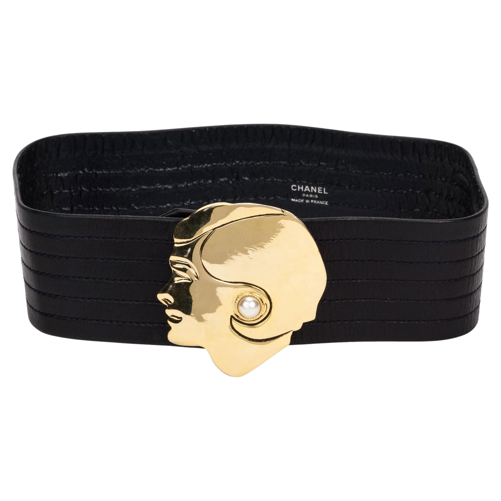 Chanel 1990s Black Leather Belt Gold Coco Buckle Pearl 70cm: Chanel 1990s Black Leather Belt Gold Coco Buckle Pearl 70cm This exquisite 1990's Chanel black leather belt features a striking gold buckle designed with the profile of Coco Chanel adorned with a pear
