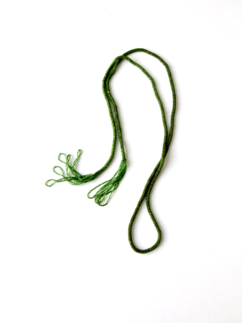 Victorian Green Glass Bead Lariat Necklace with Loop Tassels: Victorian Green Glass Bead Lariat Necklace with Loop Tassels This is an antique Victorian era necklace featuring green glass beads arranged in a long strand design. The necklace is detailed with loope
