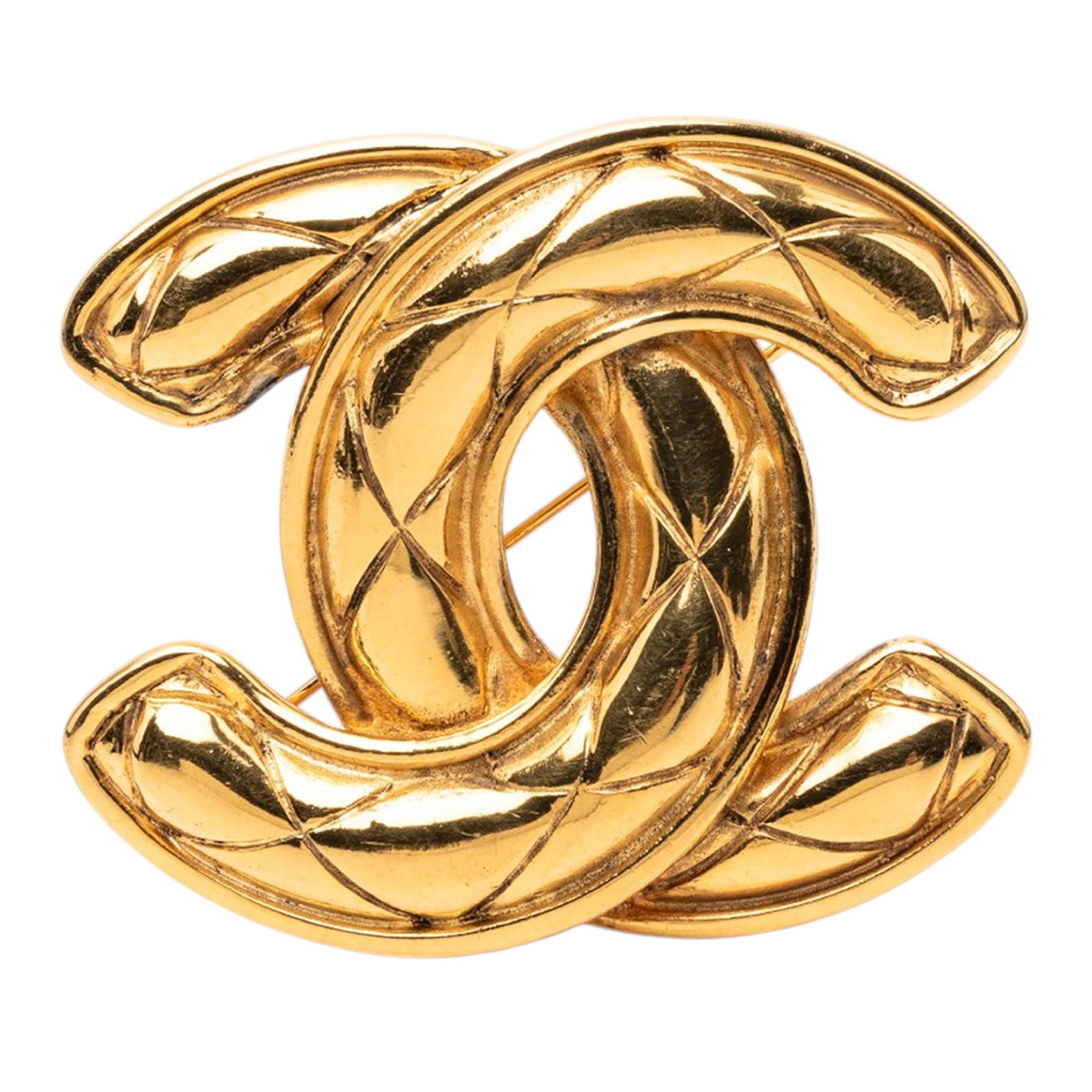 Chanel CC Quilted Gold Tone Metal Brooch: Chanel CC Quilted Gold Tone Metal Brooch Gold-tone metal brooch with a quilted design and back pin closure. Made in France, this costume piece measures 4.80 cm in length and 5.60 cm in width. Conditio