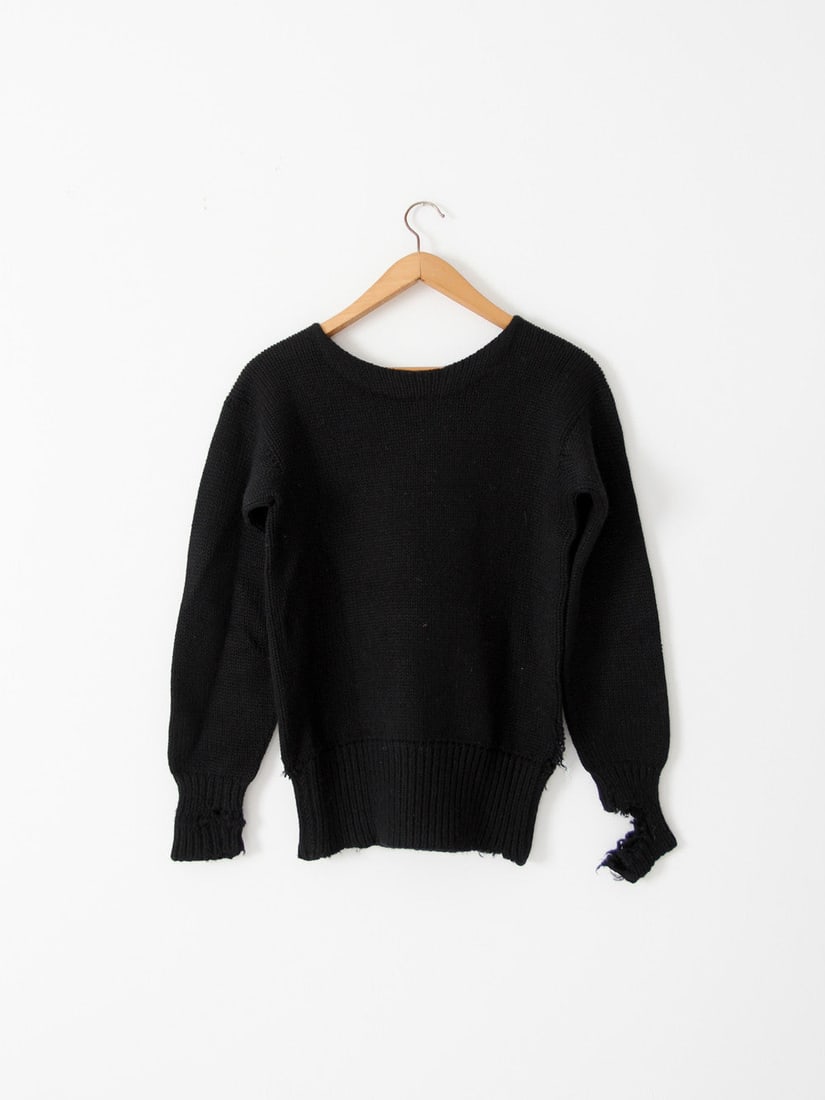 Vintage 1930s Black Wool Distressed Sweater with Patchwork Repair: Vintage 1930s Black Wool Distressed Sweater with Patchwork Repair Discover the charm of this vintage 1930s black knit sweater, expertly crafted from wool. Its beautifully distressed appearance showcas
