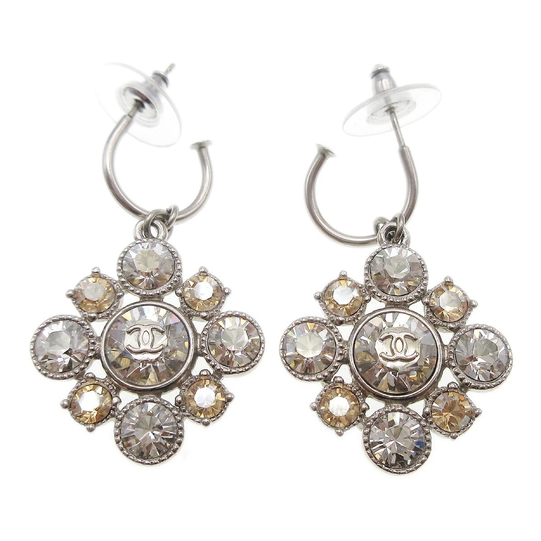 Chanel A12V silver plated dangle earrings with rhinestones: Chanel A12V silver plated dangle earrings with rhinestones Pair of Chanel dangle pierced earrings with rhinestone accents and silver-plated metal. Made in France, these earrings feature a pierced scre