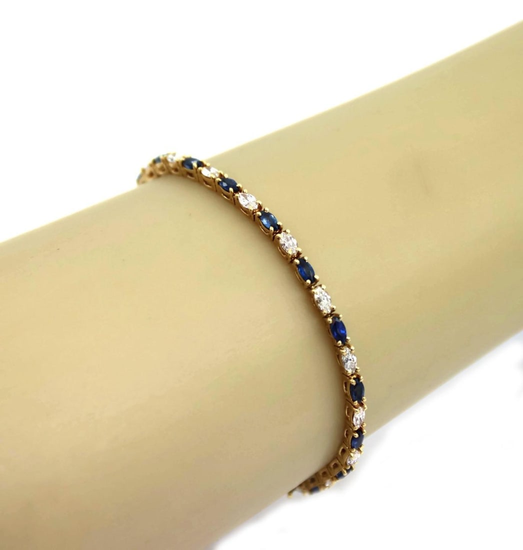 Elegant 4.5 Carat Marquise Diamond Sapphire 18k Gold Bracelet: Elegant 4.5 Carat Marquise Diamond Sapphire 18k Gold Bracelet This exquisite bracelet showcases a stunning combination of 4.5 carats of marquise cut diamonds and vibrant blue sapphires, elegantly set 
