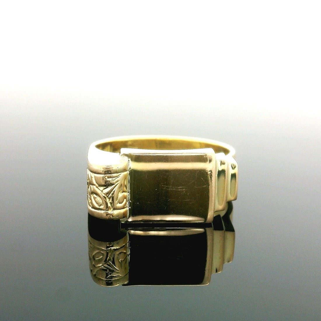 Vintage 14K Yellow Gold Polished Signet Ring with Scroll Work: Vintage 14K Yellow Gold Polished Signet Ring with Scroll Work This vintage signet ring is crafted from solid 14K yellow gold, showcasing a polished rectangular design with exquisite scroll work. Weigh