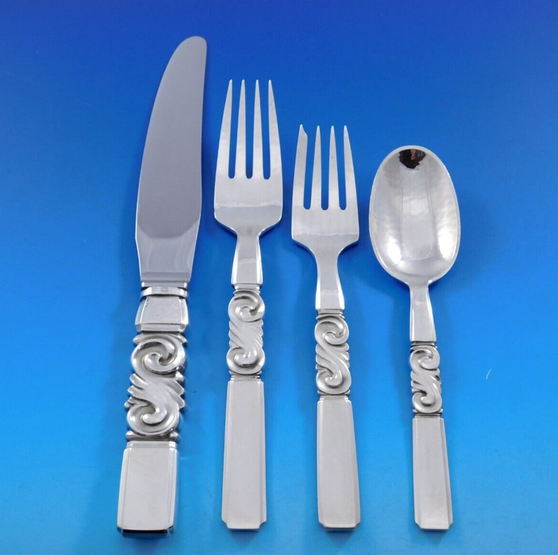 Georg Jensen Scroll Sterling Silver 4-Pc Dinner Place Setting: Georg Jensen Scroll Sterling Silver 4-Pc Dinner Place Setting Experience the elegance of the Scroll pattern by Georg Jensen with this exquisite 4-piece sterling silver dinner size place setting. This 