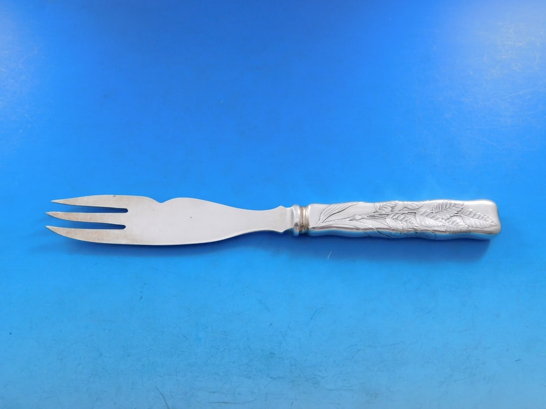 Tiffany Sterling Silver Lap Over Edge Melon Fork Knife 8 1/8 with Leaves Motif: Tiffany Sterling Silver Lap Over Edge Melon Fork Knife 8 1/8 with Leaves Motif This exquisite sterling silver melon fork/knife features a beautiful Lap Over Edge pattern, acid etched by Tiffany & Co. 