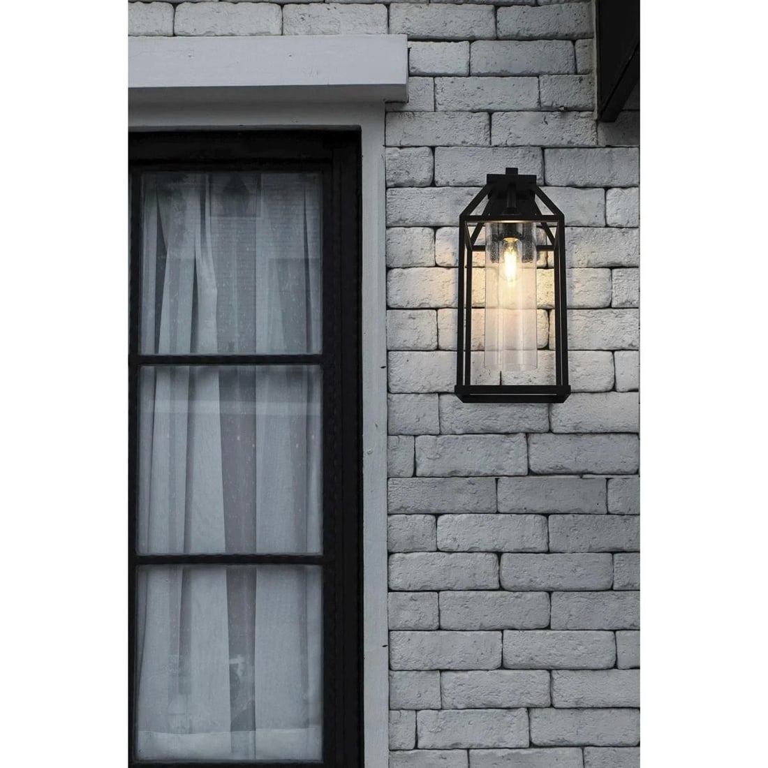 Zora Outdoor Wall Lantern Black Seedy Glass 24.25 in: Zora Outdoor Wall Lantern Black Seedy Glass 24.25 in Traditional outdoor wall sconce light fixture with a black finish and seedy glass. It is hardwired, wall mounted, and designed for indoor or outdoo